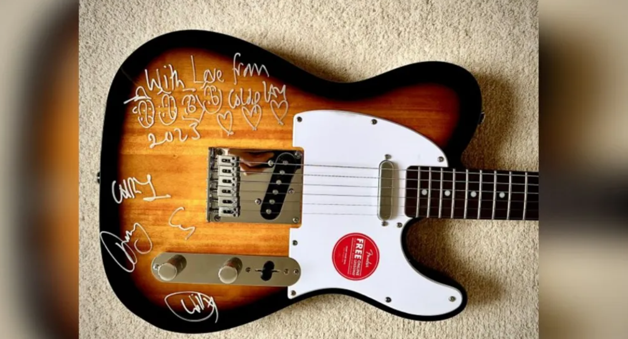 Signed Coldplay guitar raises £3,500 for two schools near Frome